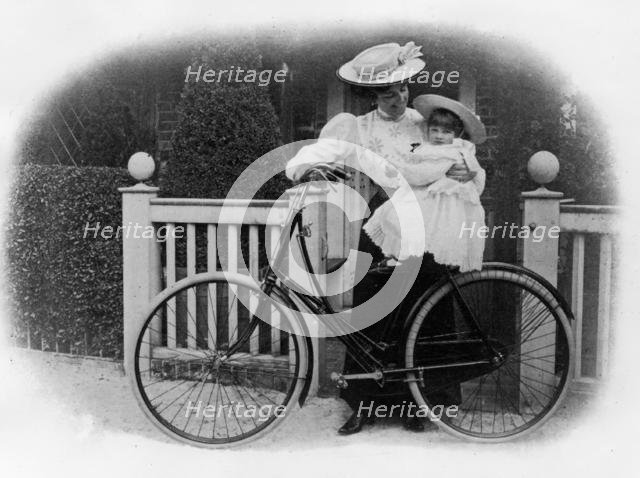 Beeston Humber cycle, Mrs. Hicks with child. Creator: Unknown.
