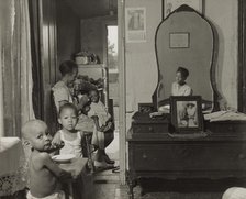 Dinner time at the home of Mrs. Ella Watson, a government charwoman, Washington, D.C., 1942. Creator: Gordon Parks.