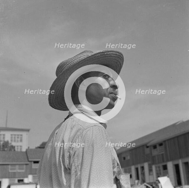 Negro waterboy for a housing construction gang, Washington, D.C., 1942. Creator: Gordon Parks.