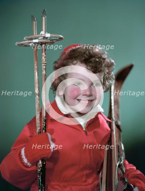 Young girl with cross-country ski equipment, c1955.  Creator: Arthur Charles Kirby Ware.