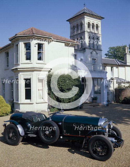 A 1930 Bentley Supercharged outside a house. Artist: Unknown