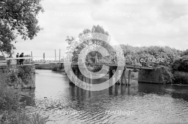 A group of men contemplate a footbridge over the River Medway at Barming, c1945-c1965. Artist: SW Rawlings