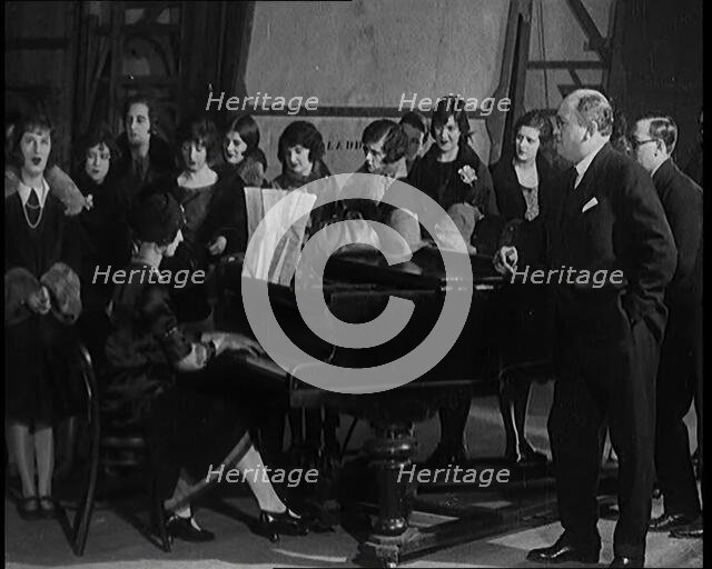 Female Civilian Singing Scales Badly Whilst Other Female Civilian is Playing the Piano in..., 1920s. Creator: British Pathe Ltd.