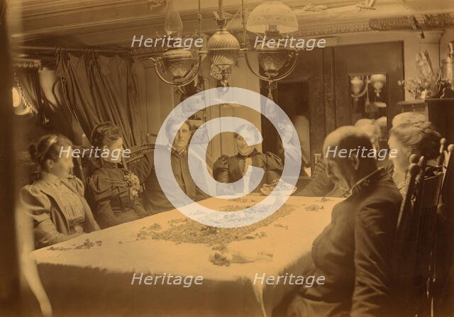 Captains, their wives, and two female tourists sitting around a table aboard ship...,Alaska, (1897?) Creator: Alfred Lee Broadbent.