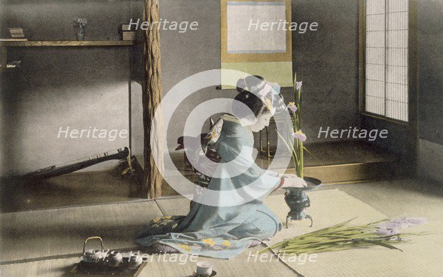 Girl arranging flowers, 1890's. Creator: Japanese Photographer (19th Century).