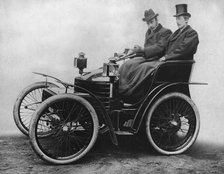 Herbert Austin at tiller of first 4 wheel Wolseley 1899. Creator: Unknown.