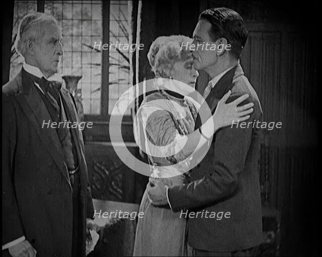 An Extract from a Silent Film. A Female Actor and a Male Actor Embrace. Another Male Actor..., 1920s Creator: British Pathe Ltd.
