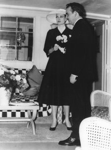 Prince Rainier and Grace Kelly in the saloon of the royal yacht, Monaco harbour, 1950s. Artist: Unknown