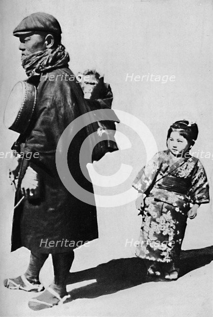 ''With his drum and monkey he is Japan's equivalent to our old-style organ grinder', c1900, (1921).  Artist: Julian Leonard Street.