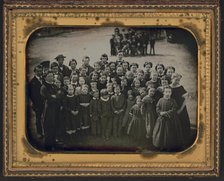 Large group of school children, with their teacher, standing in a town street, ca. 1850s. Creator: Unknown.