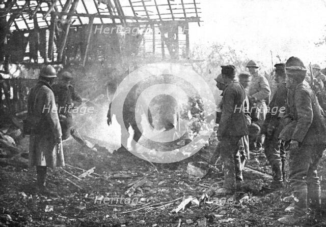'Dans Cantigny; au milieu de la fumee des lance-flammes, les Allemands, un par un..., 1918. Creator: Unknown.