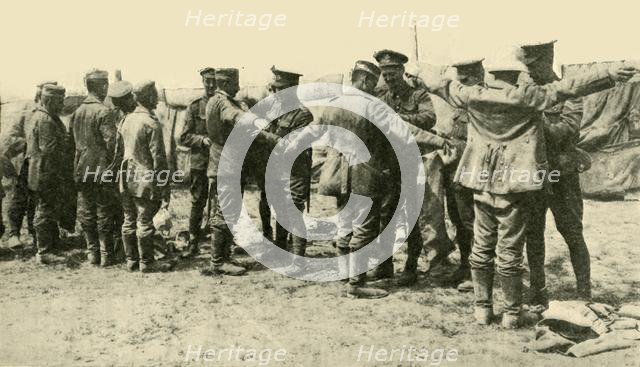'After the Battle: searching German prisoners of war...', First World War, c1916, (c1920).  Creator: Unknown.