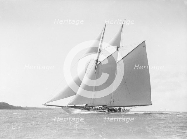 The 250 ton schooner 'Germania' reaching in stiff wind, 1912. Creator: Kirk & Sons of Cowes.