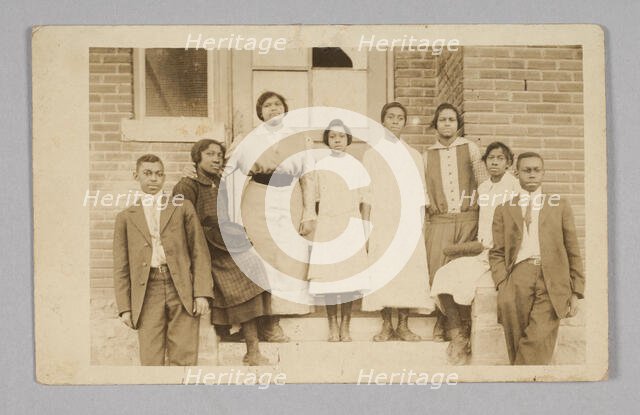 Photographic print of 8 people in front of a building, 1904-1918. Creator: Unknown.