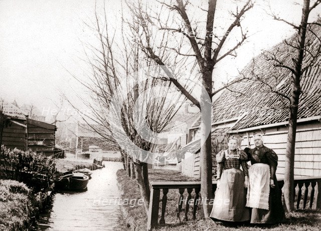 Two women on a canal bank, Broek, Netherlands, 1898.Artist: James Batkin