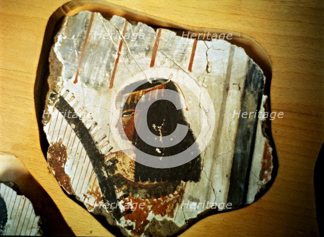 Fragment of a fresco from Thebes, showing a woman playing the harp.