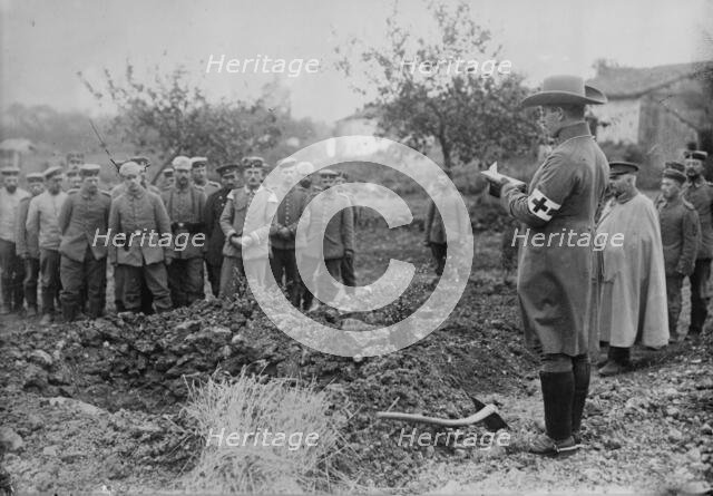 German Field chaplain burying French Officer who died in hospital, 1914. Creator: Bain News Service.
