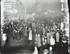 Crowds in Deptford High Street shopping after dark, London, 1913. Artist: Unknown.