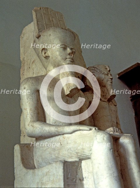 Amon seated next to Tutankhamun, statue made in calcite, 1350 BC.