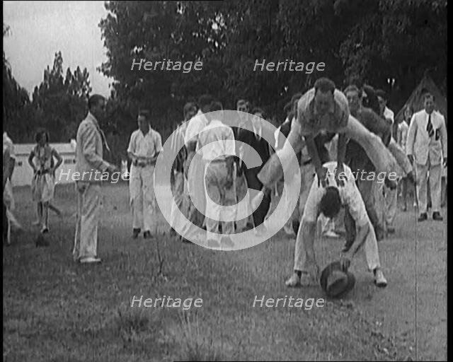 A Male Civilian Leapfrogging over Another Male Civilian Outdoors in a Holiday Camp, 1920. Creator: British Pathe Ltd.