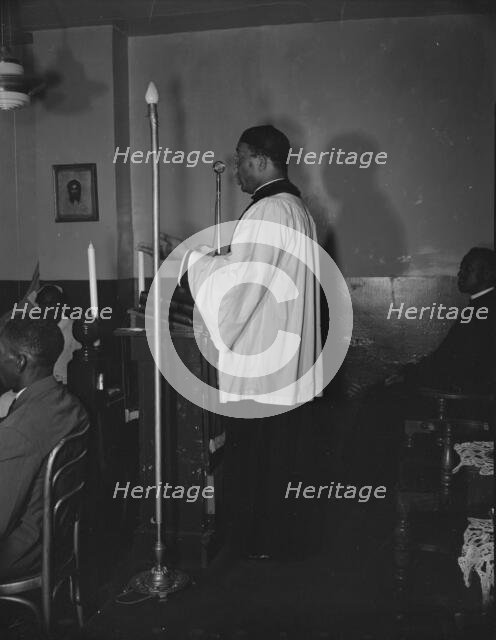 Reverend Vondell Gassaway, pastor of the St. Martin's Spiritual Church..., Washington, D.C., 1942. Creator: Gordon Parks.