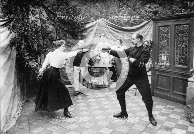 Man and woman fencing (?), between c1910 and c1915. Creator: Bain News Service.