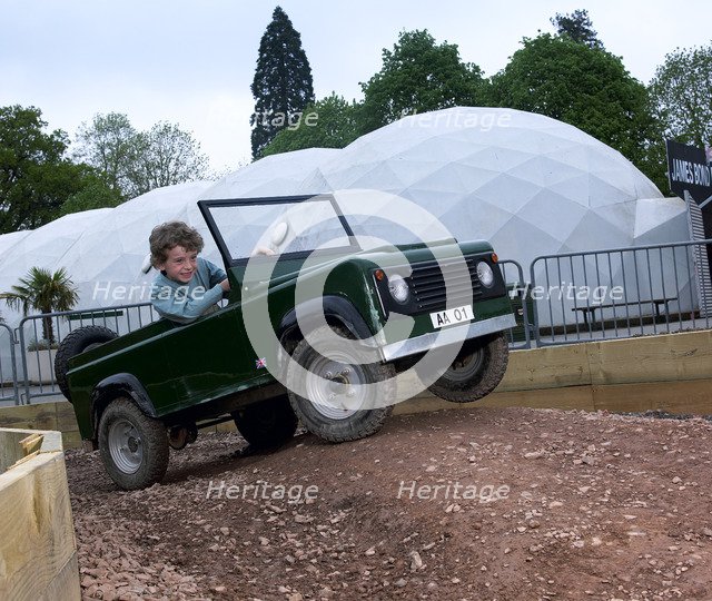 Child driving a toy Land Rover. Artist: Unknown.