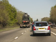 Locomotive being transported by heavy goods vehicle on A31 2015. Creator: Unknown.