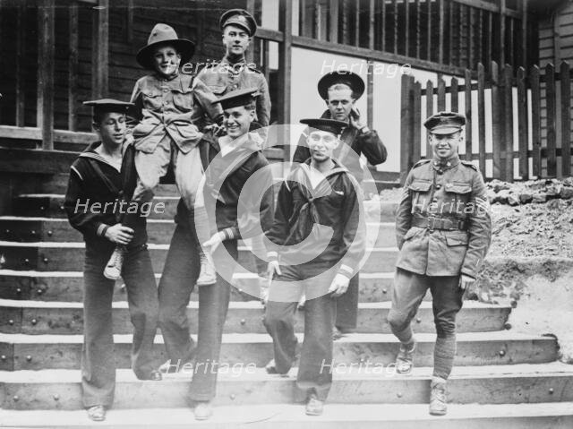 Digby Morton, Phila. Boy Scout, and U.S. Jackies at "Eagle" hut in London, between c1915 and 1918. Creator: Bain News Service.