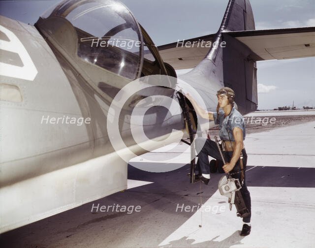It's an intricate operation - installing a 30-calibre machine gun...Corpus Christi, Texas, 1942. Creator: Howard Hollem.