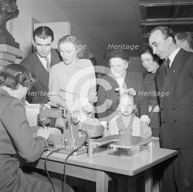 A woman demonstrates a sewing machine, Landskrona, Sweden, 1951. Artist: Unknown