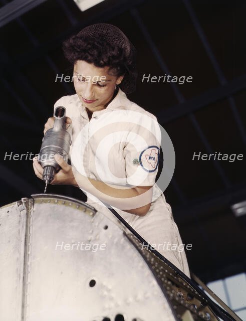 Oyida Peaks riveting as part of her NYA training...Naval Air Base, Corpus Christi, Texas, 1942. Creator: Howard Hollem.