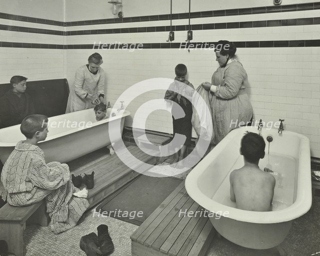 Attendants bathing boys at the Sun Court Cleansing Station, London, 1914. Artist: Unknown.