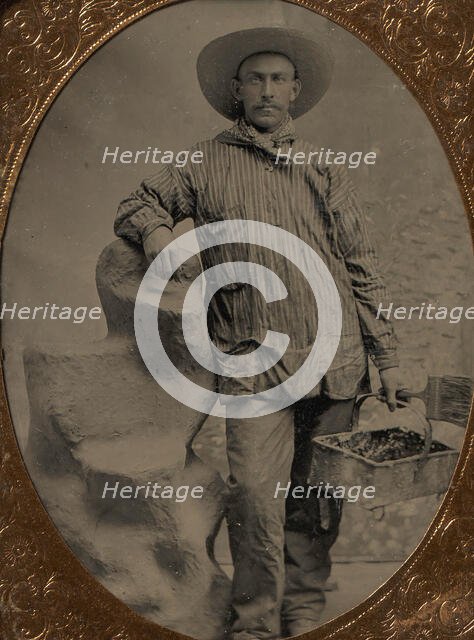 Workman Holding Brush and Rectangular Tray, Arm Resting on Fake Rock, 1860s-80s. Creator: Unknown.