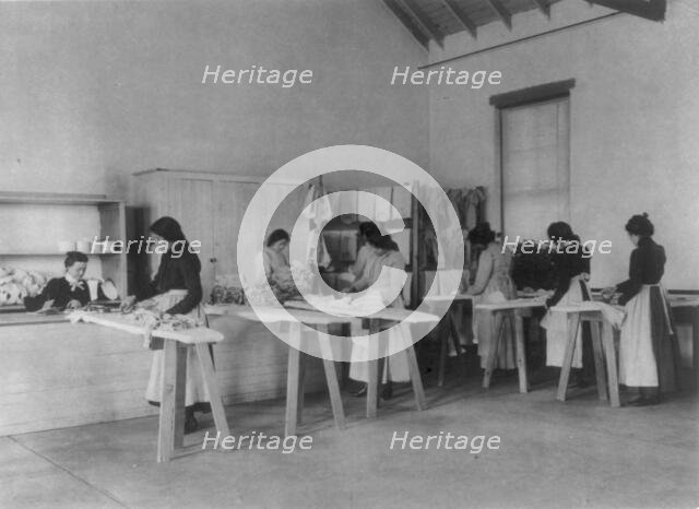 Classroom scenes at Carlisle, Pa., Indian School. Ironing; women students, 1901. Creator: Frances Benjamin Johnston.
