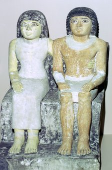 Limestone Egyptian statue of a man and his wife. Artist: Unknown