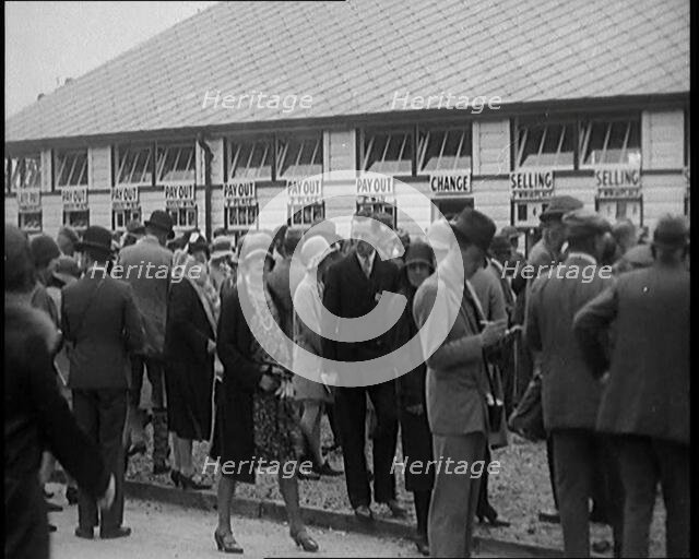 A Crowd of People Standing Outside a Totaliser/Tote Office at a Horse Race Course..., 1929. Creator: British Pathe Ltd.