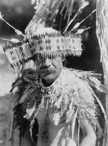 Man in Pomo dance costume, half-length portrait, facing front, c1924. Creator: Edward Sheriff Curtis.
