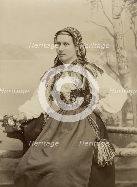 A young woman poses in a folk costume, 1890-1920. Creator: Helene Edlund.