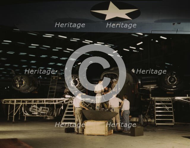Getting a nose door ready to put on a C-87...Consolidated Aircraft Corp..., Fort Worth, Texas, 1942. Creator: Howard Hollem.