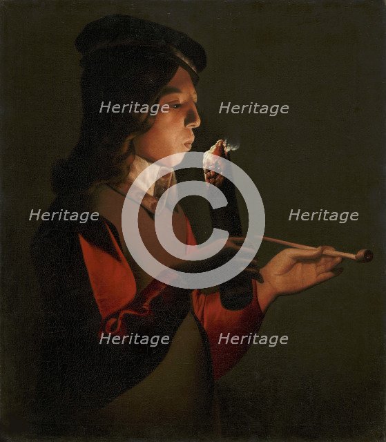 A young boy with a pipe, blowing on a firebrand, 1645-1648.