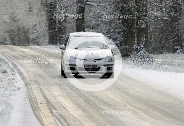2003 Nissan Almera driving on icy road in winter Artist: Unknown.
