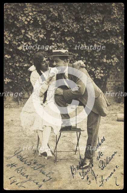 Two actors, one in drag, pose on garden furniture, 1918. Creator: Unknown.