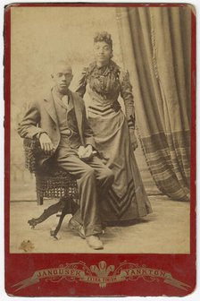 Photograph of African-American man and woman in formal clothes, late 19th century. Creator: Louis Janousek.