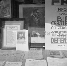 Signs in the windows of a Marcus Garvey club in the Harlem area, 1943. Creator: Gordon Parks.