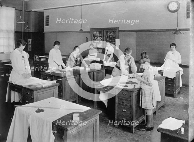 Girl Scouts - War Sewing with Red Cross, 1917. Creator: Harris & Ewing.