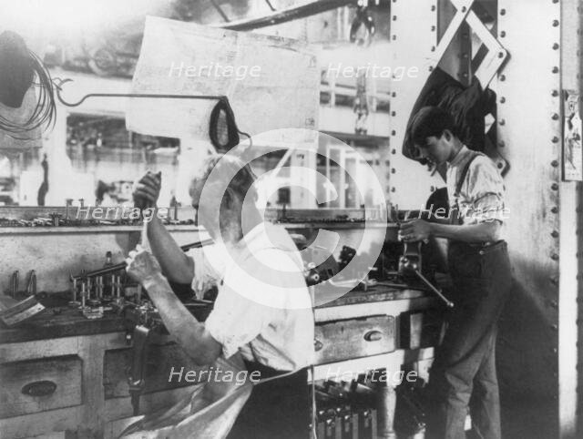 U.S. Naval Gun Factory. Wash. D.C. 2 men working at bench, 1903. Creator: Frances Benjamin Johnston.