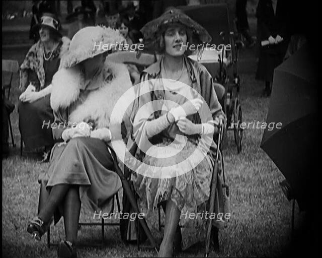 Three Female Civilians Seating Outdoors Wearing Evening Outfits and Hats, 1920. Creator: British Pathe Ltd.