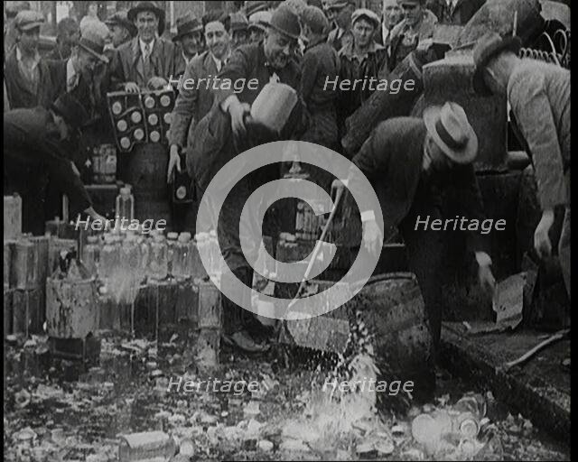 Prohibition Scenes in the United States of America. Men Smashing Bottles of Alcoholic..., 1920. Creator: British Pathe Ltd.
