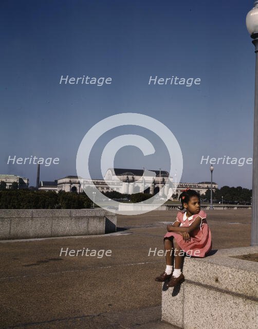 Little girl in a park with Union Station in the background, Washington, D.C., ca. 1943. Creator: Unknown.